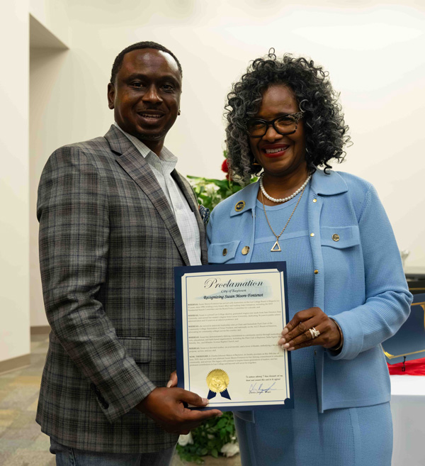 Former Regent Susan Moore-Fontenot and Baytown Mayor Charles Johnson hold a proclamation from the City of Baytown honoring Moore-Fontenot's 37 years of service to the Board of Regents. 